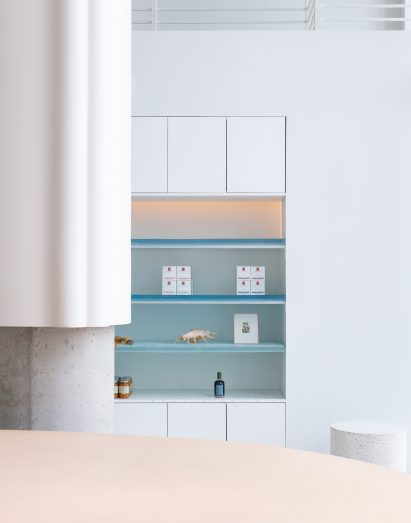 Blue shelves in white clad cafe