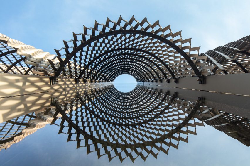 Curved perforated aluminium screens on a glass facade