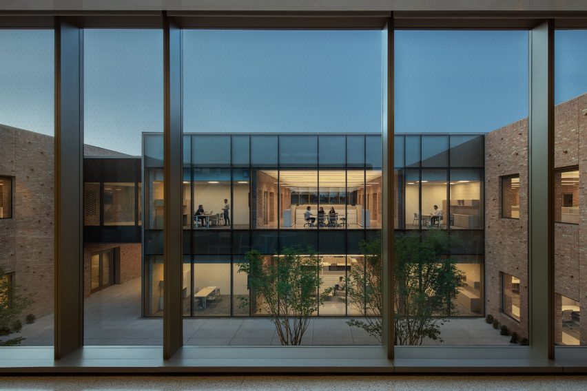 Windows overlooking a courtyard with a double-storey glass building