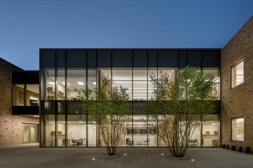 Courtyard surrounded by a two-storey glazed building by John Ronan Architects