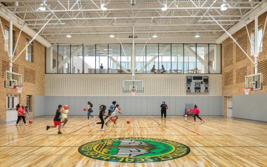 Indoor basketball court with exposed brick walls