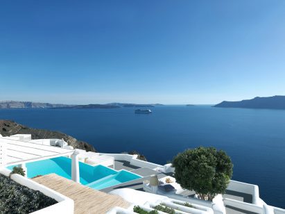 White buildings and swimming pool stepping down cliffs