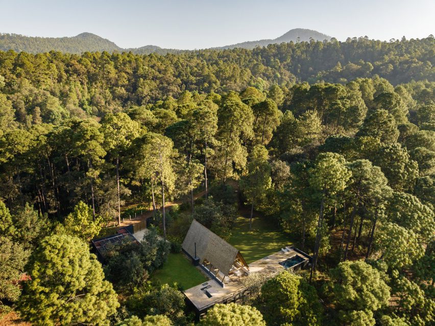 An a-frame house on top of a rectangular house