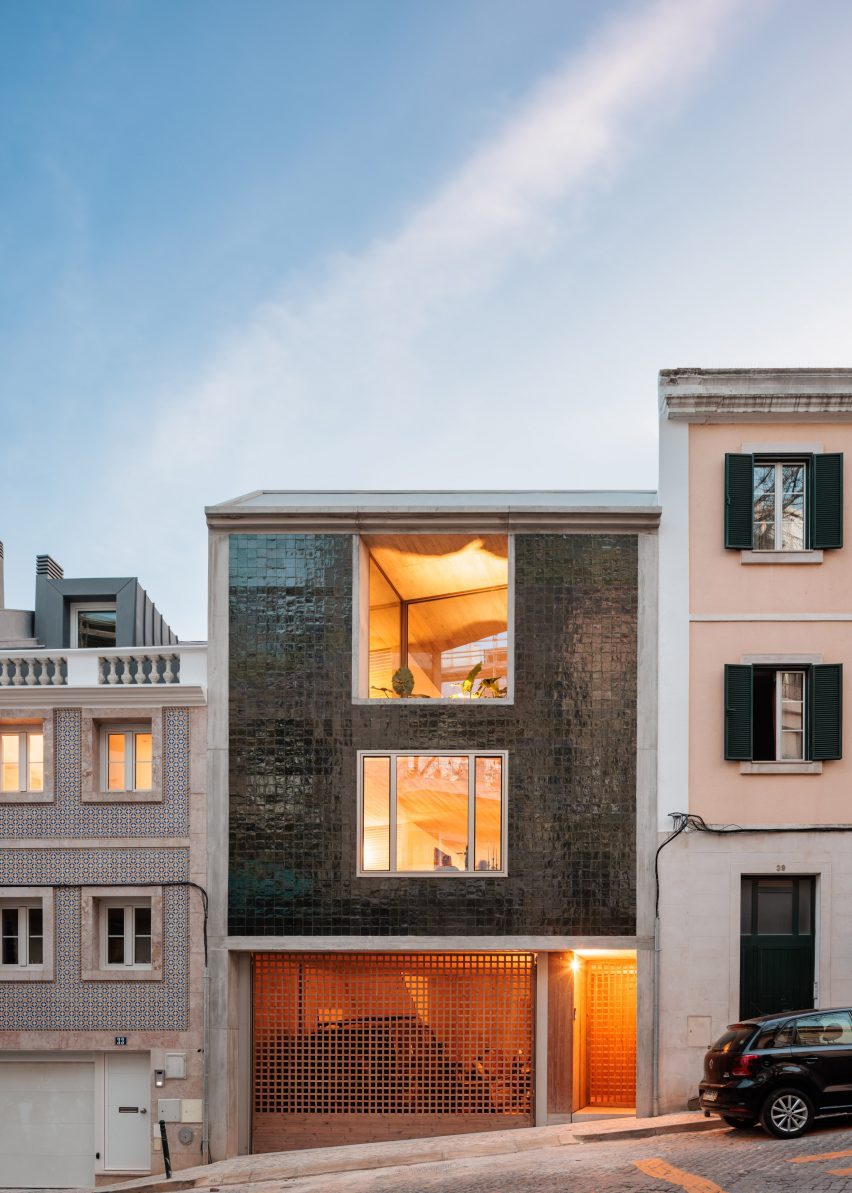 Exterior of a concrete home in Lisbon with green-tiled facade