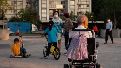 Man in wheelchair and kids playing