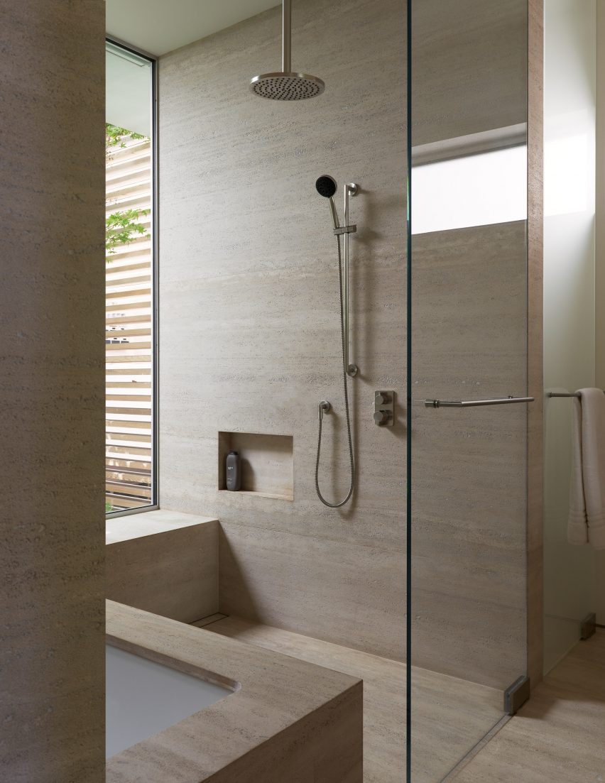 Walk-in shower with stone-like surfaces