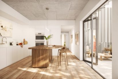 A kitchen with a large wooden island overlooking a patio