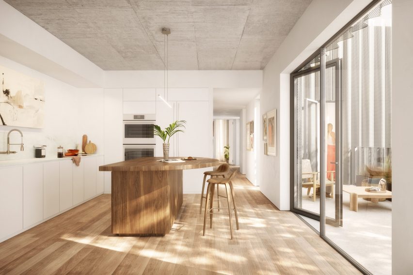 A kitchen with a large wooden island overlooking a patio