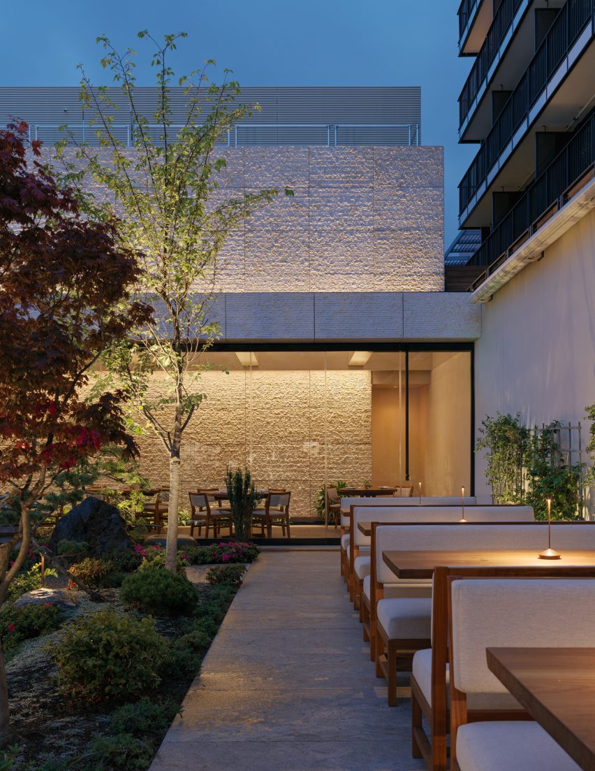 A restaurant with a garden patio in the evening