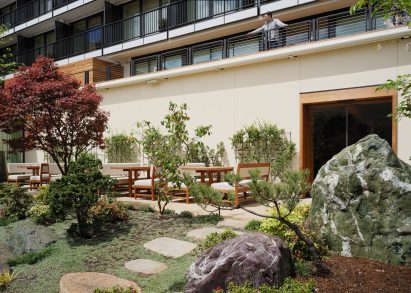 A stone pathway leading to glass doors