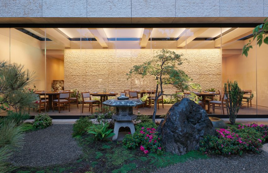 A restaurant with a garden patio in the evening
