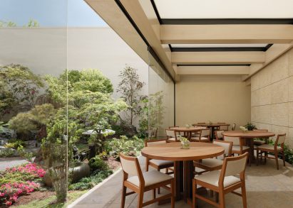 Dining tables and chairs underneath a cloth awning