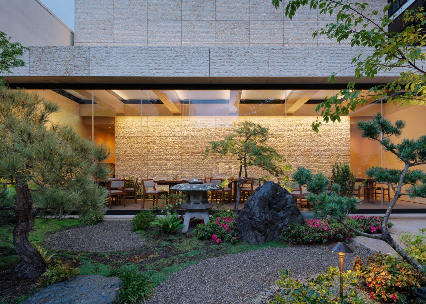 A restaurant with a garden patio in the evening