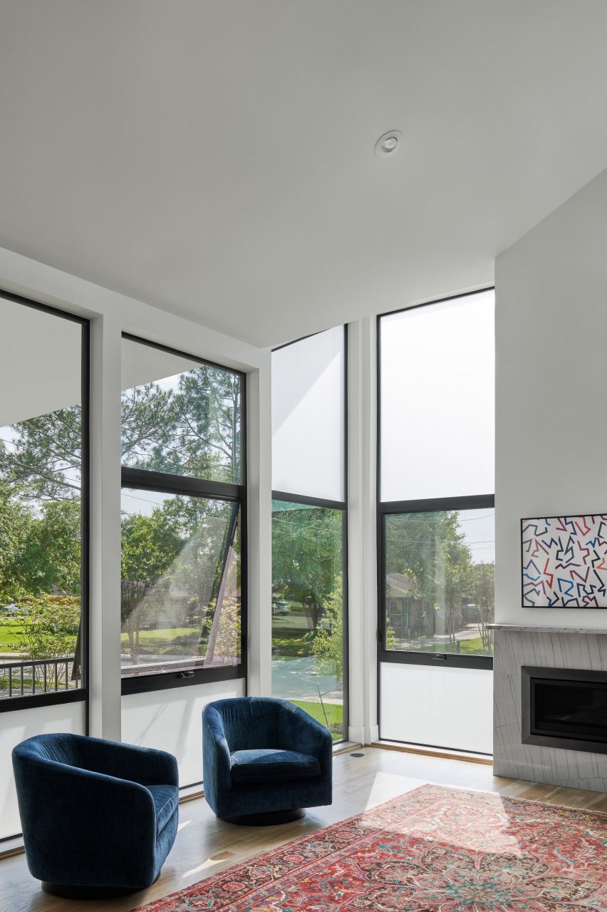 Lounge room with blue armchairs and floor-to-ceiling windows