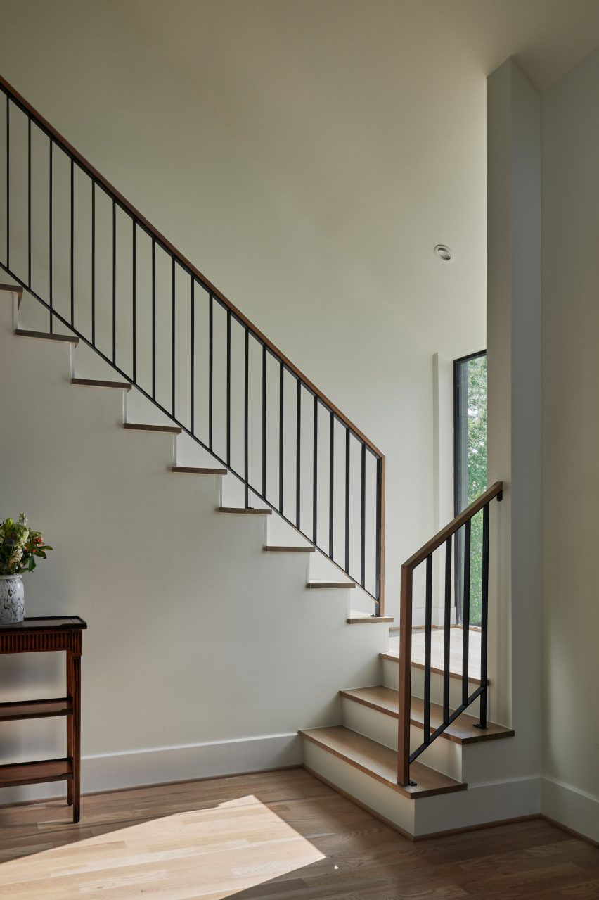 Staircase in a white room with a window