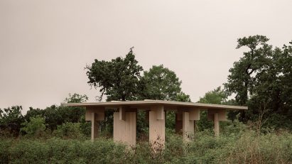 A timber pavilion located in a marsh area