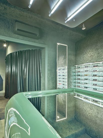 Central mirrored counter inside eyewear store in Barcelona by El Departamento
