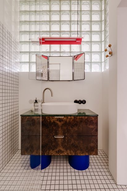 Tortoiseshell cabinet with cobalt legs in the bathroom