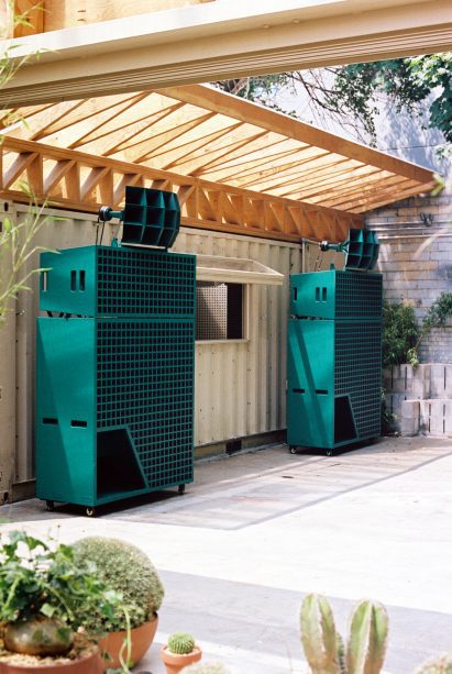 Wooden trusses over green speakers