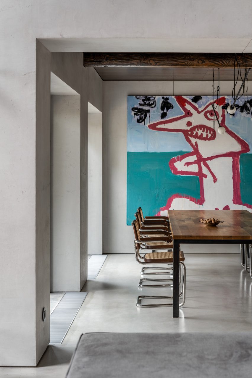 Photograph of dining room with art on back wall