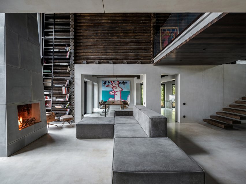 Photograph showing large sofa in living area looking into dining area