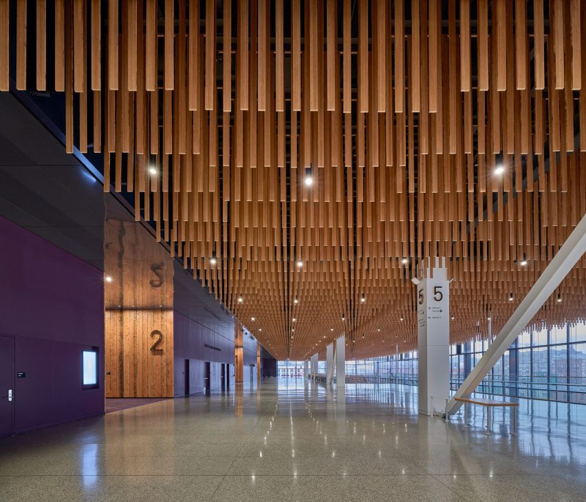 A textured ceiling made of suspended wooden planks