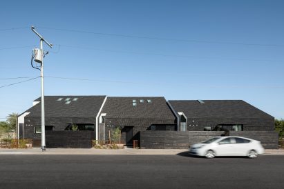 House with a pitched roof clad in asphalt shingles by SinHei Kwok