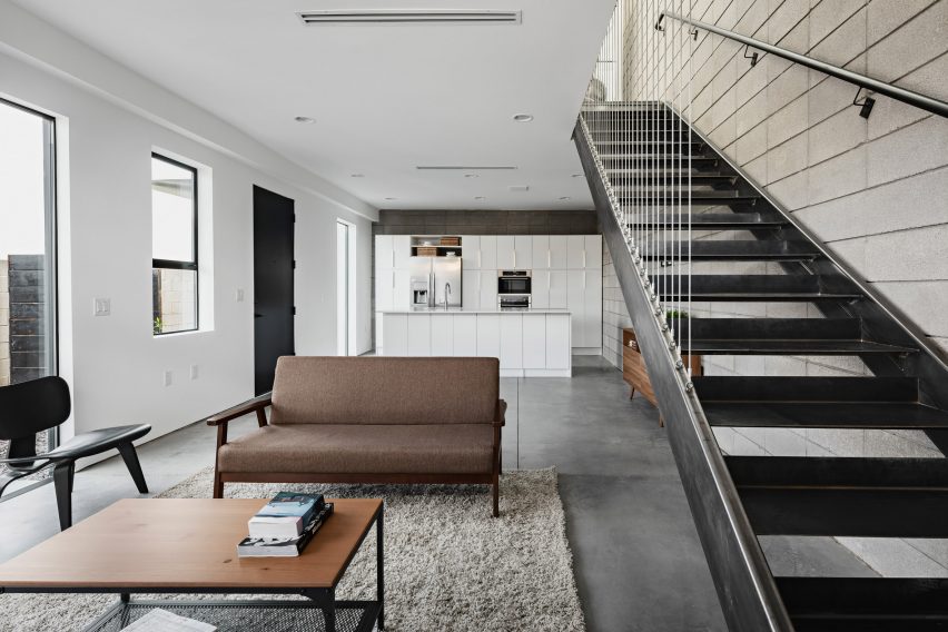 Open-plan kitchen and dining room with a steel staircase