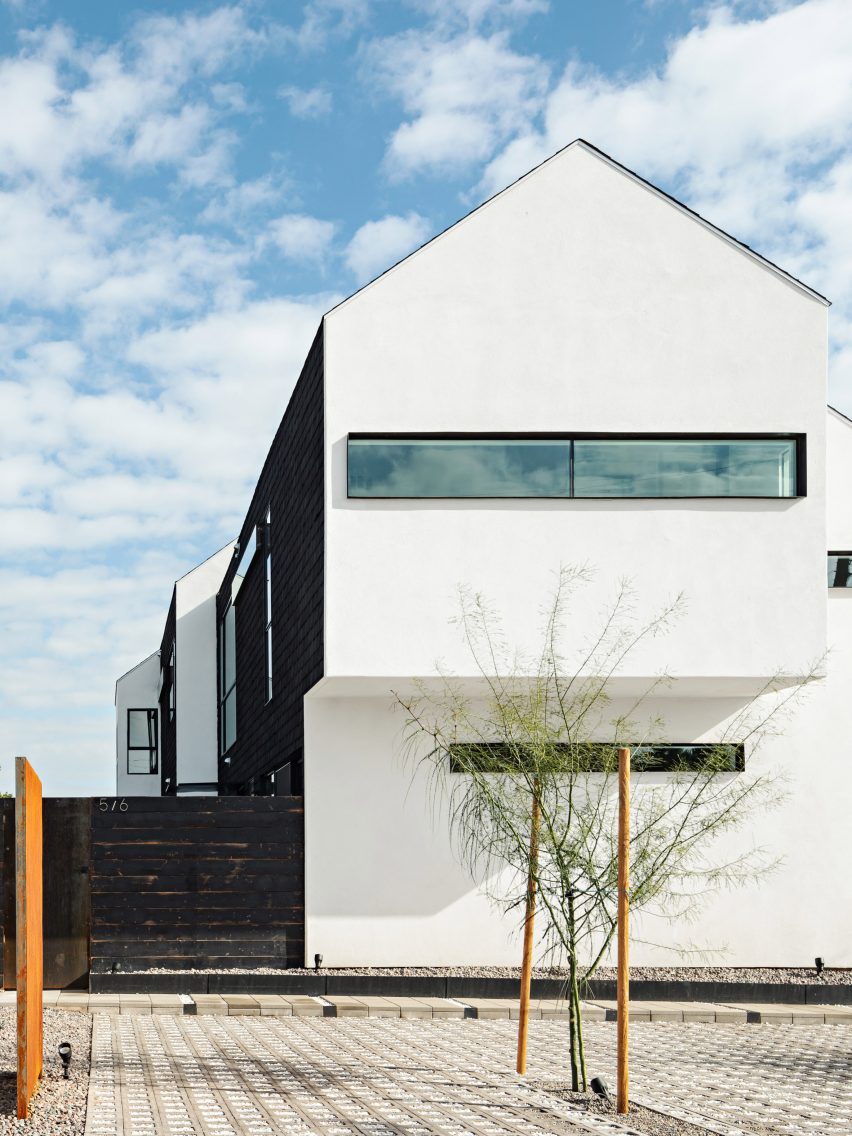 White stucco gable end of Polker House by SinHei Kwok