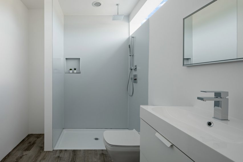 Bathroom with concrete floors and white walls