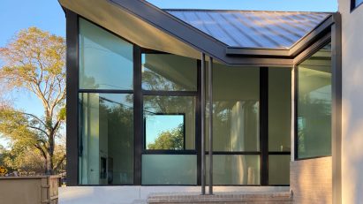 Glazed corner of a house in Houston with a lifted roof