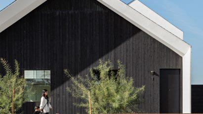 Gable end of a Phoenix house clad in black timber by SinHei Kwok