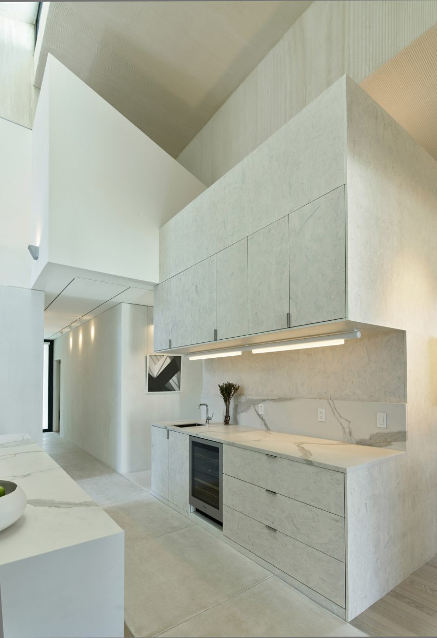 White marble kitchen in a double-height space