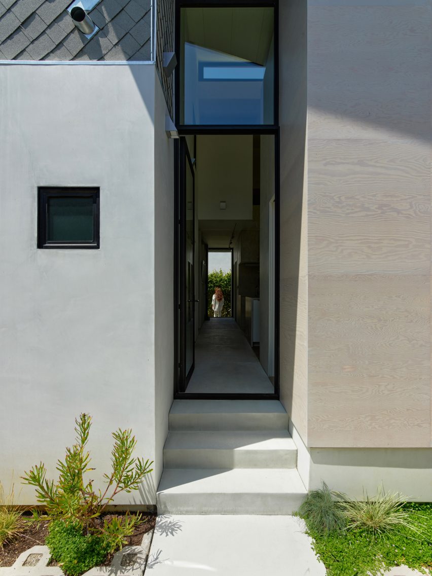 Glass door leading to a corridor at the House 5 bungalow extension by The LADG