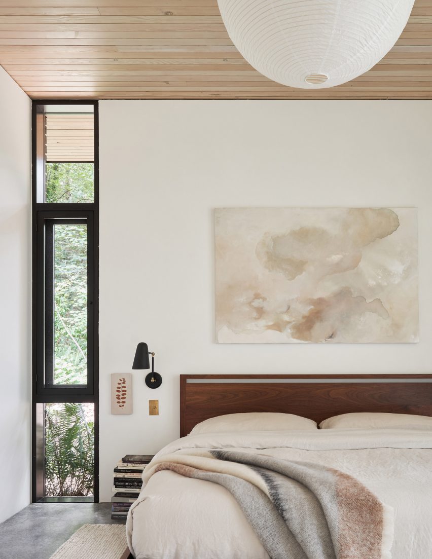 Bedroom with white walls and a timber ceiling