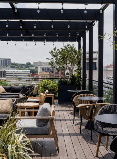 Roof terrace covered by pergola with string lights