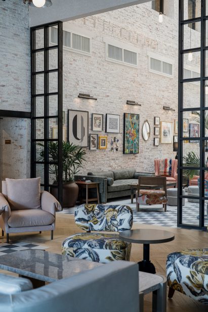 Hotel lobby in former warehouse with whitewashed brick walls