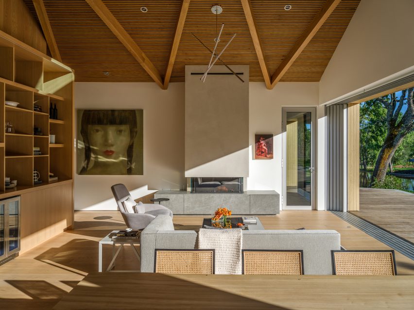 Open-plan living and dining room in a timber barn house