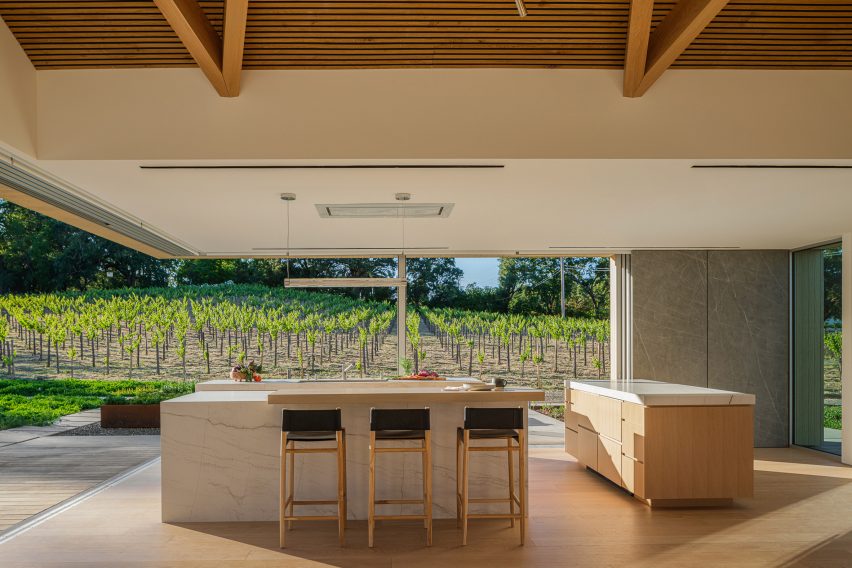 Kitchen in a timber farmhouse with walls open to the exterior