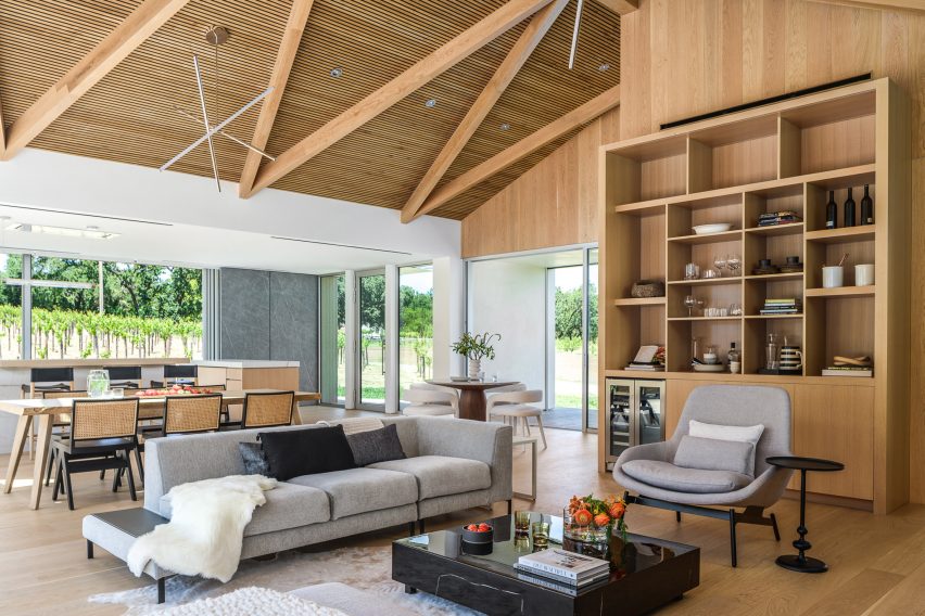 Open-plan dining and living room in a timber barn house in California