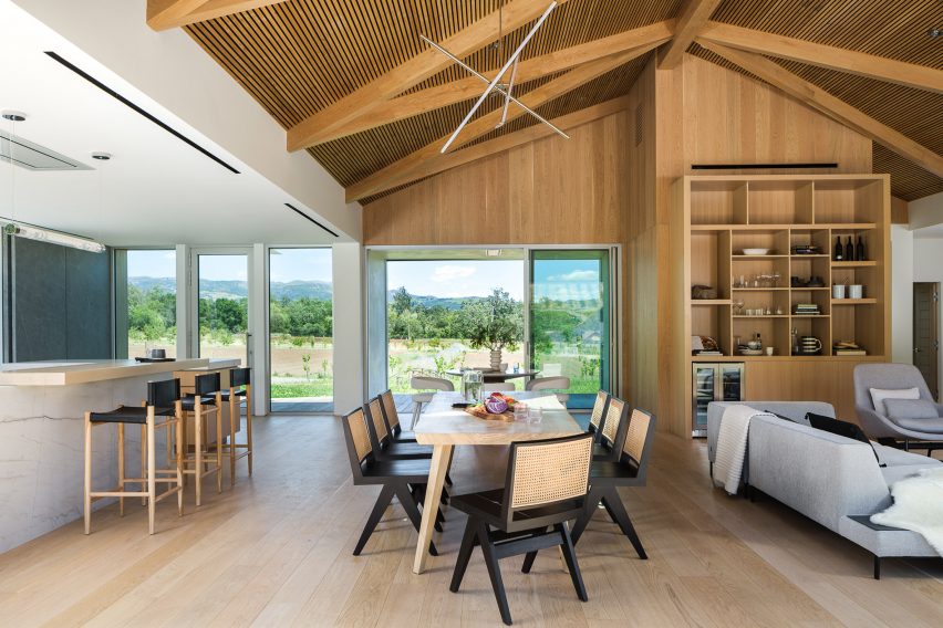 Open-plan kitchen, living and dining room in a timber barn house in California
