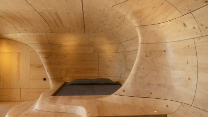 Beds in biomorphic wooden hotel room