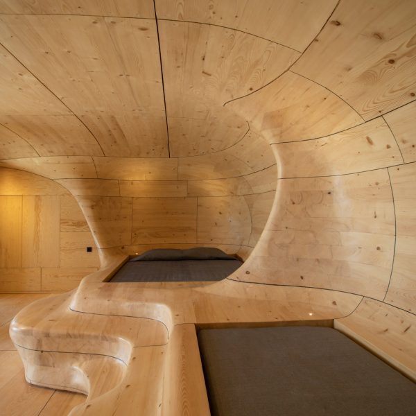 Beds in biomorphic wooden hotel room