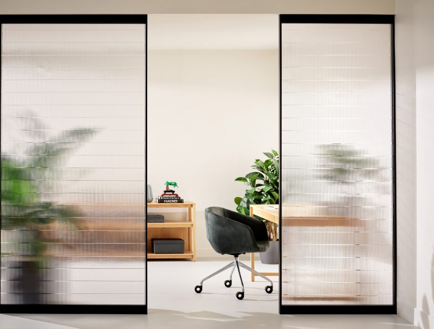 Rippled resin room divider in an office