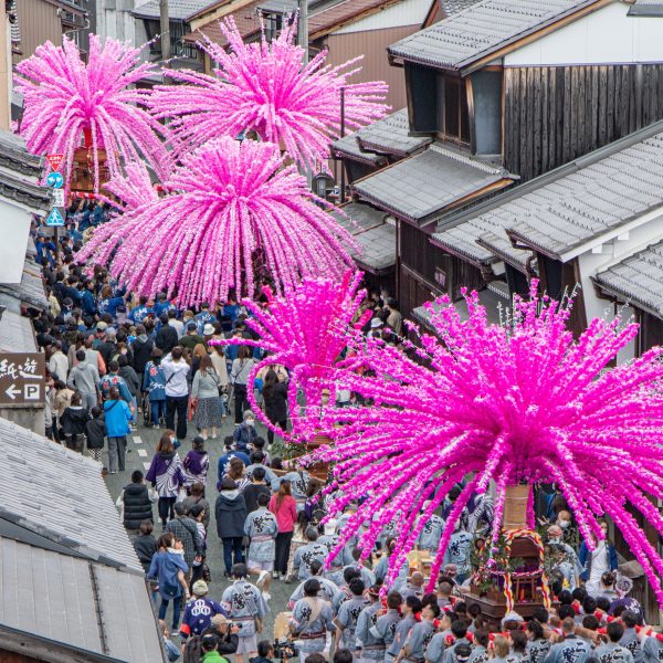 Photo of pink paper installations at a festival