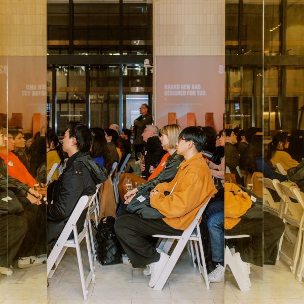 Photo of people sat on chairs at a discussion