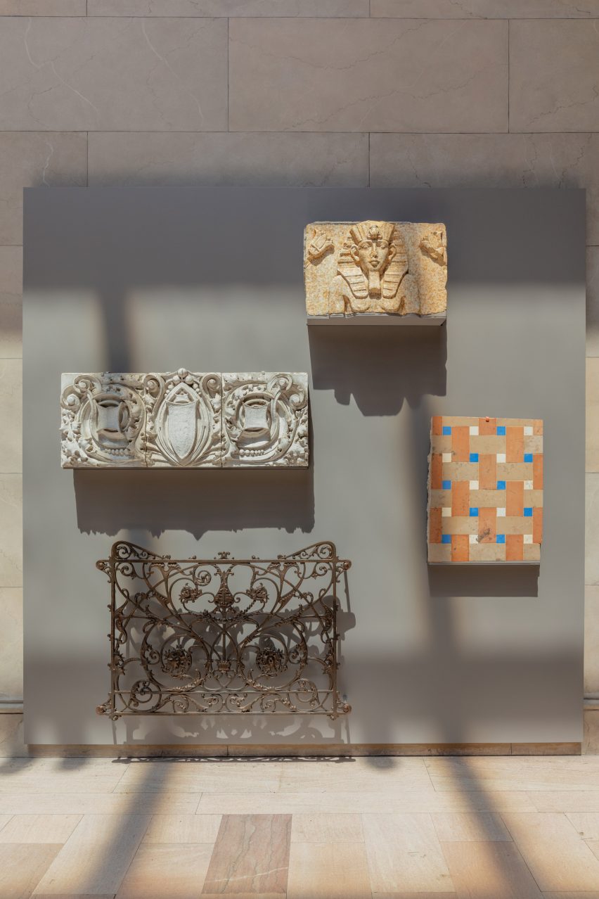 Stone and tiles affixed to a wall panel for display