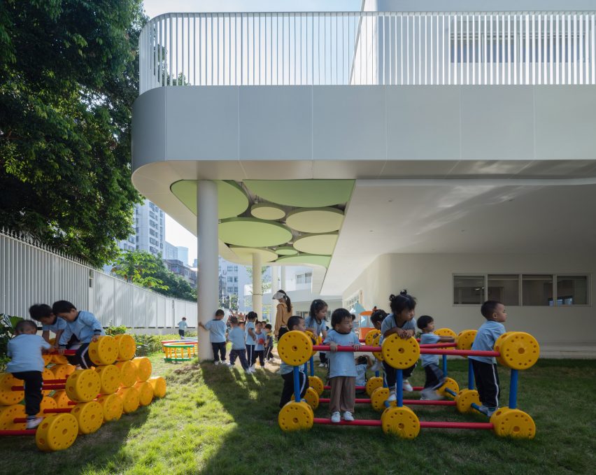 Children playing in a garden at the Kindergarten of Museum Forest by Atelier Apeiron