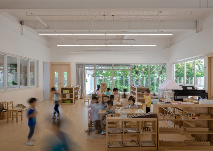 Classroom with white walls and wood flooring at the Kindergarten of Museum Forest by Atelier Apeiron