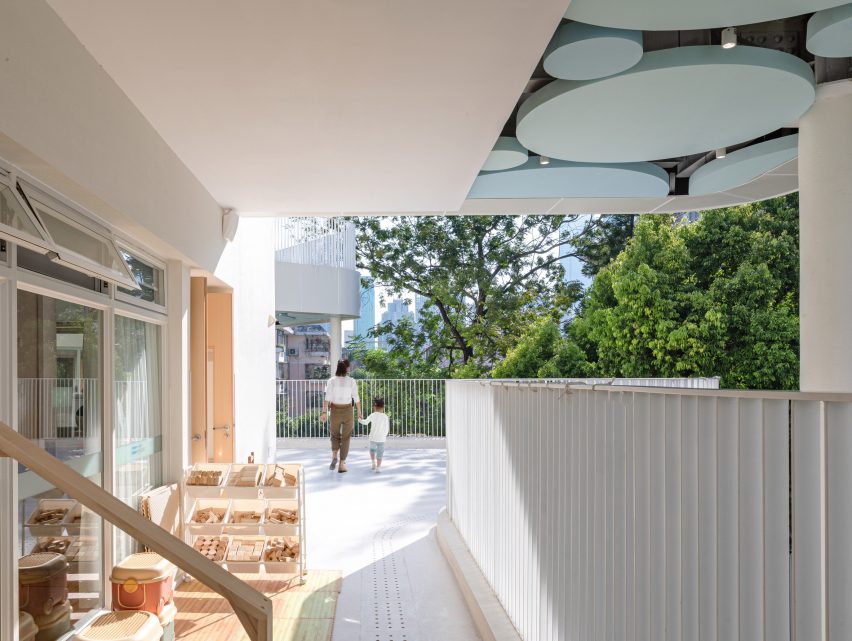 White outdoor terrace at the Kindergarten of Museum Forest by Atelier Apeiron